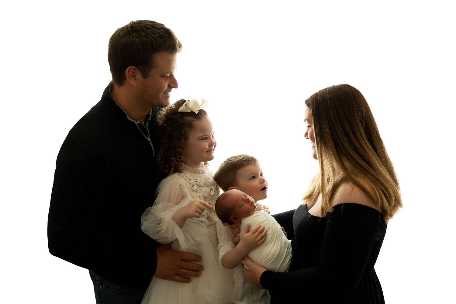 Family portrait silhouette showing parents holding two small children against white background.