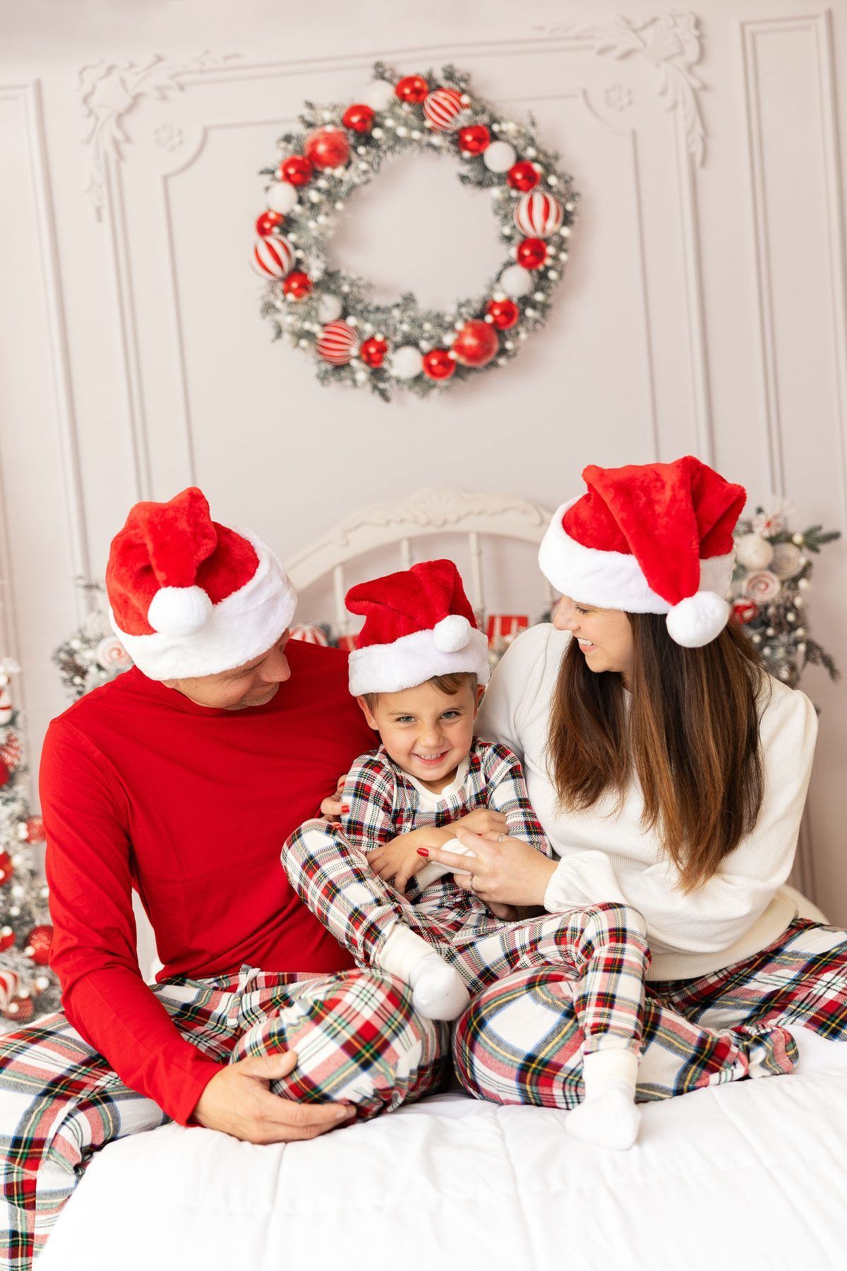 Family in Santa hats and matching plaid Christmas pajamas, Monterey Christmas family photos