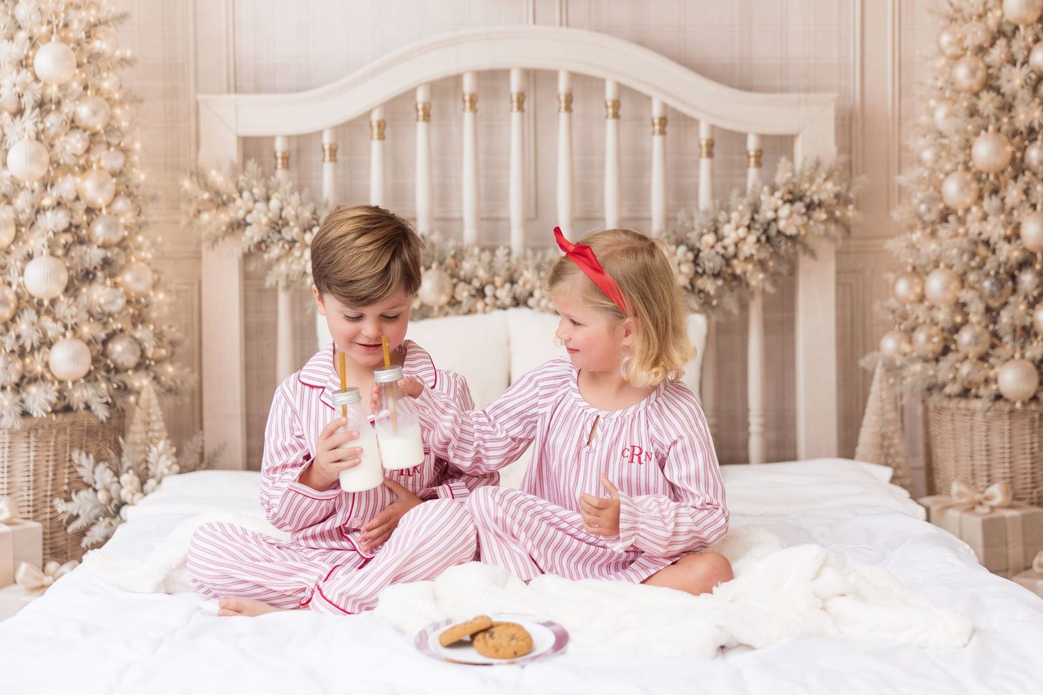 Siblings in matching Christmas jammies on the 2026 Milk & Cookies holiday mini session set in Pacific Grove
