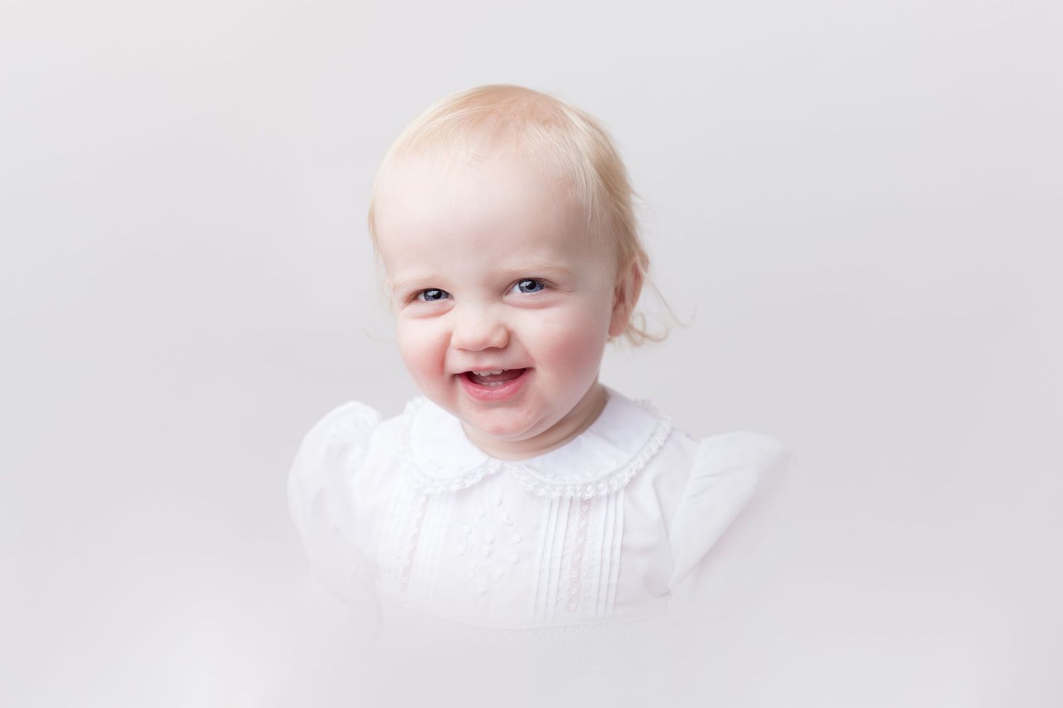Simple white baby portraits showing sweet expressions.