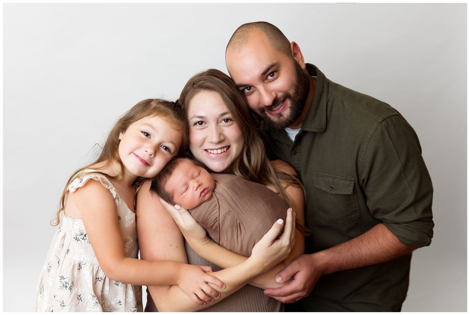A heartwarming family portrait series showing loving embraces and joyful moments together against a neutral backdrop.