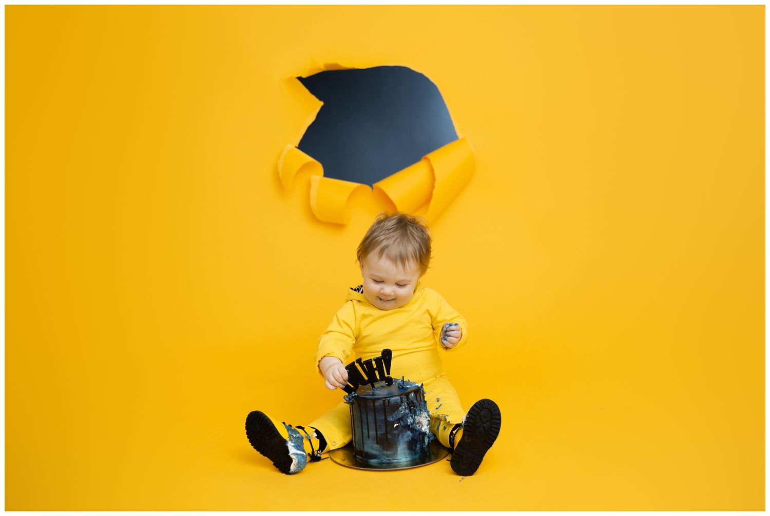 Yellow background photo series shows baby sitting in different positions and wearing a graduation cap.