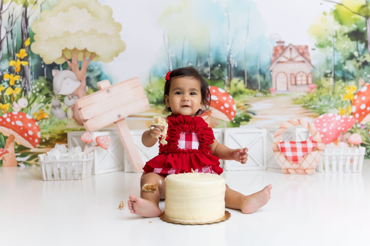 Garden themed cake smash setup with floral backdrop and yellow cake.