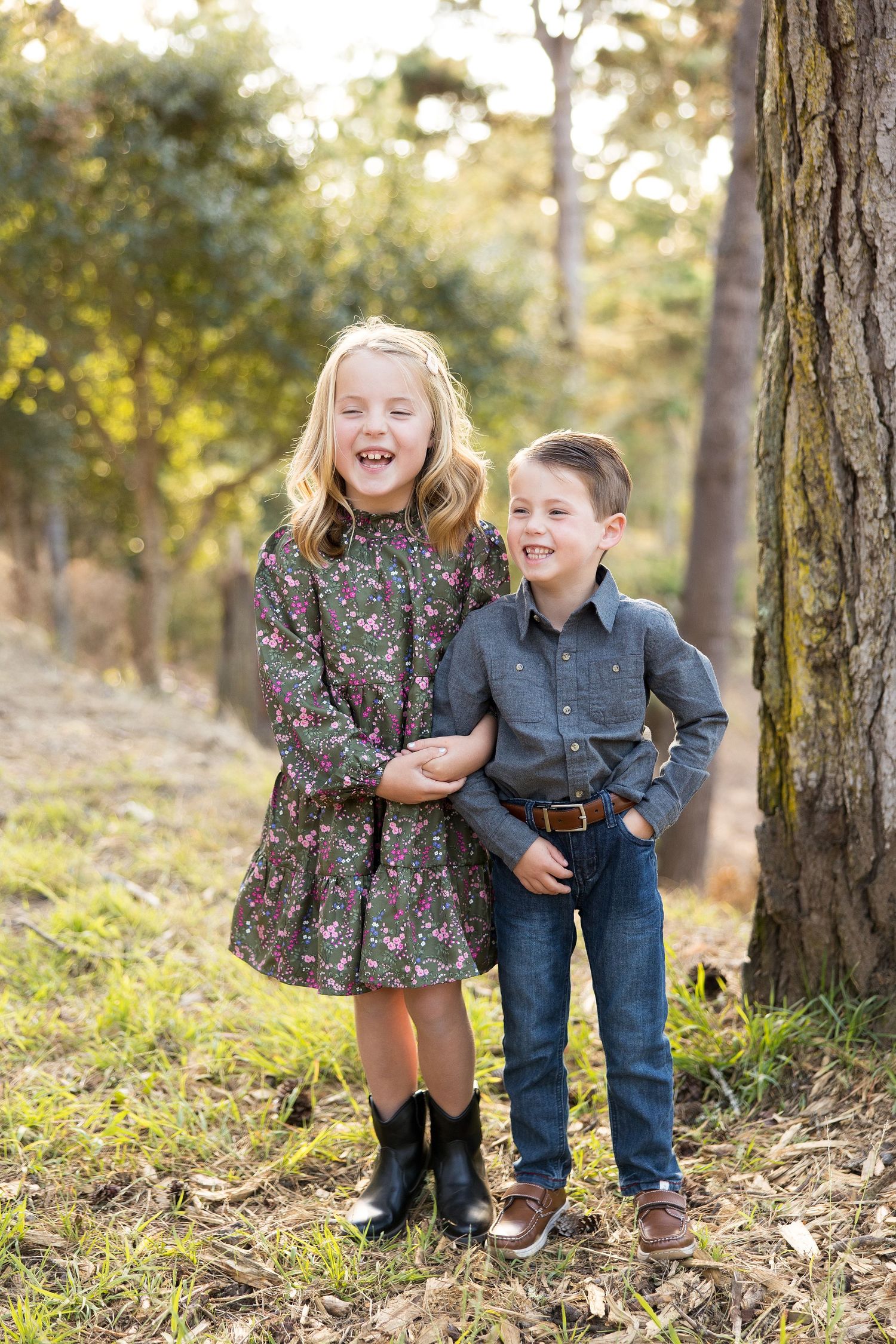 siblings during family photos in pacific grove forest