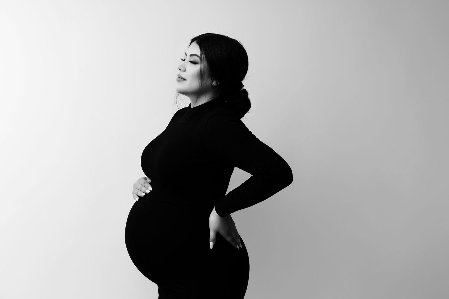 Artistic black and white maternity silhouette showing pregnancy profile.