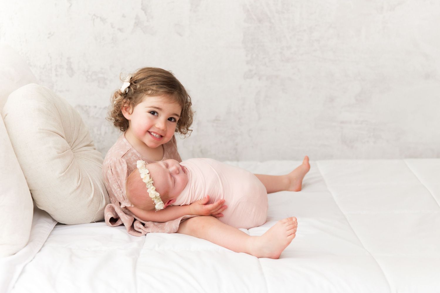Gentle family portrait series in white featuring intimate moments on light backdrop.