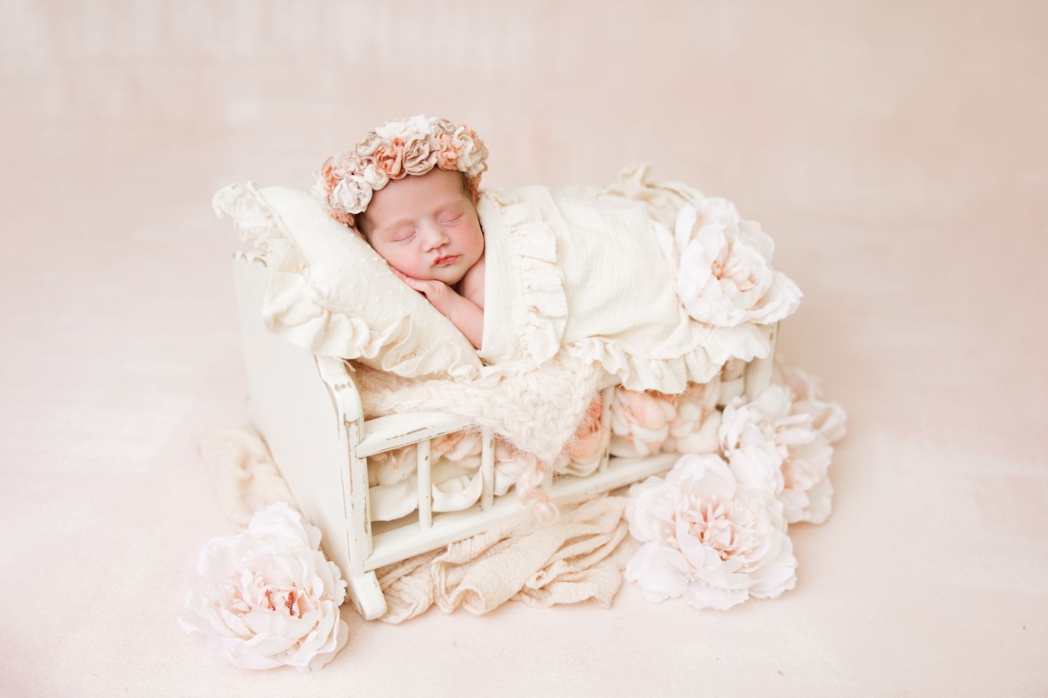 A series of soft, dreamy newborn baby portraits in light beige and cream tones arranged in a collage.