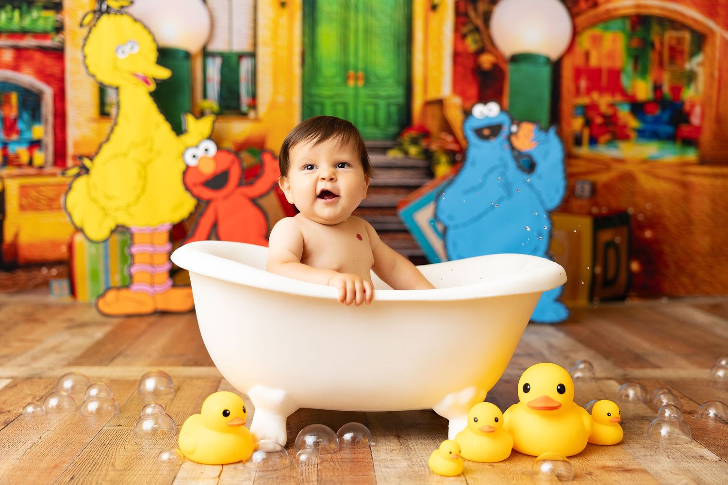 Rubber ducks surround white bathtub in Sesame Street themed photoshoot setting.