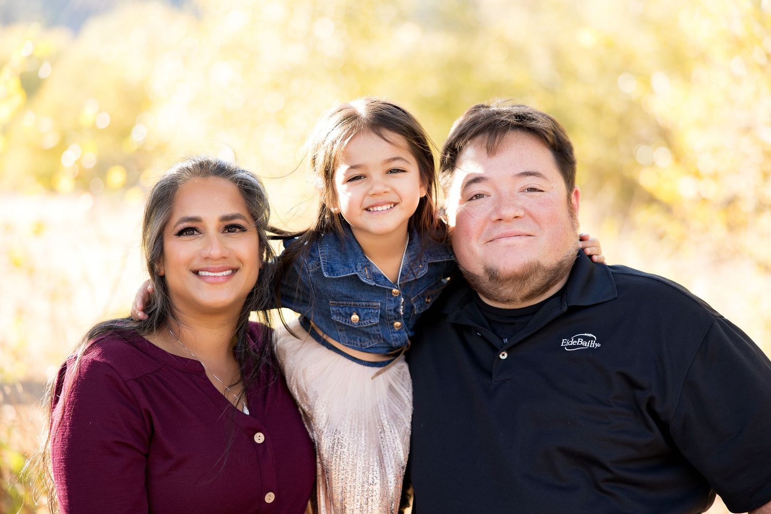 A family portrait series capturing warm moments together outdoors in autumn light.
