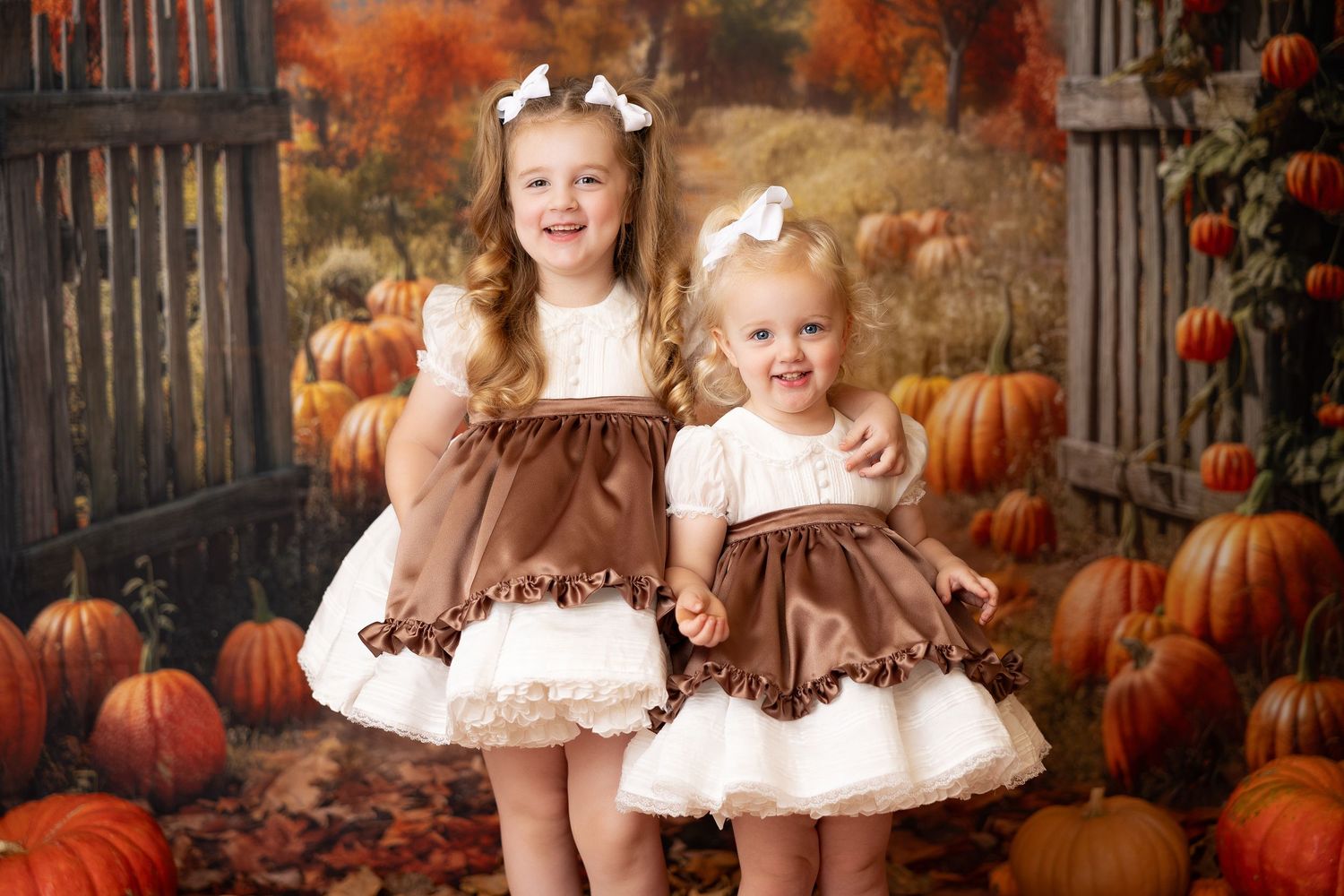 Autumn pumpkin patch photography setup with rustic wooden fence and fall colors.