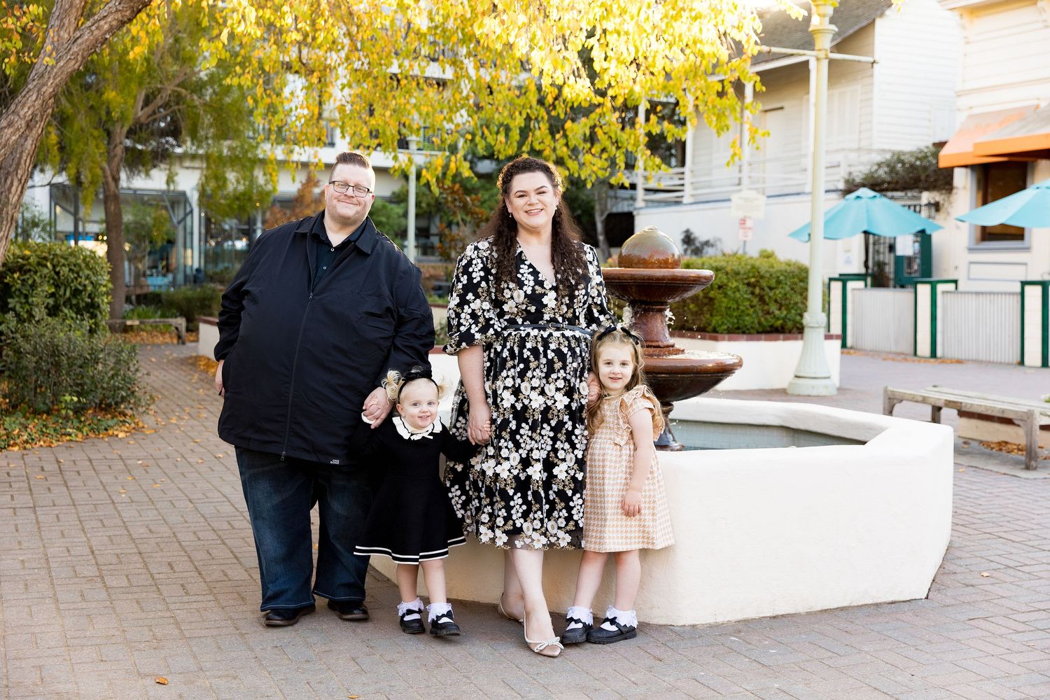 Family autumn portrait session outdoors with fall foliage in background.