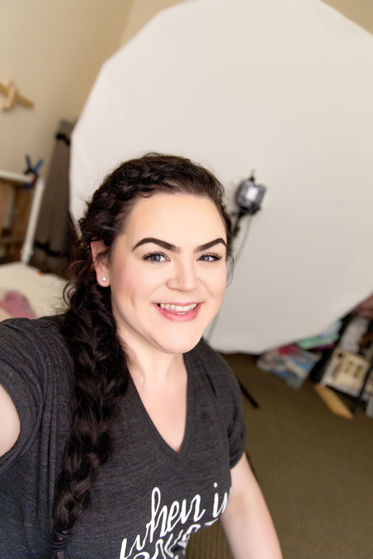A series of selfies showing someone with dark hair wearing a black graphic t-shirt in various poses and expressions.
