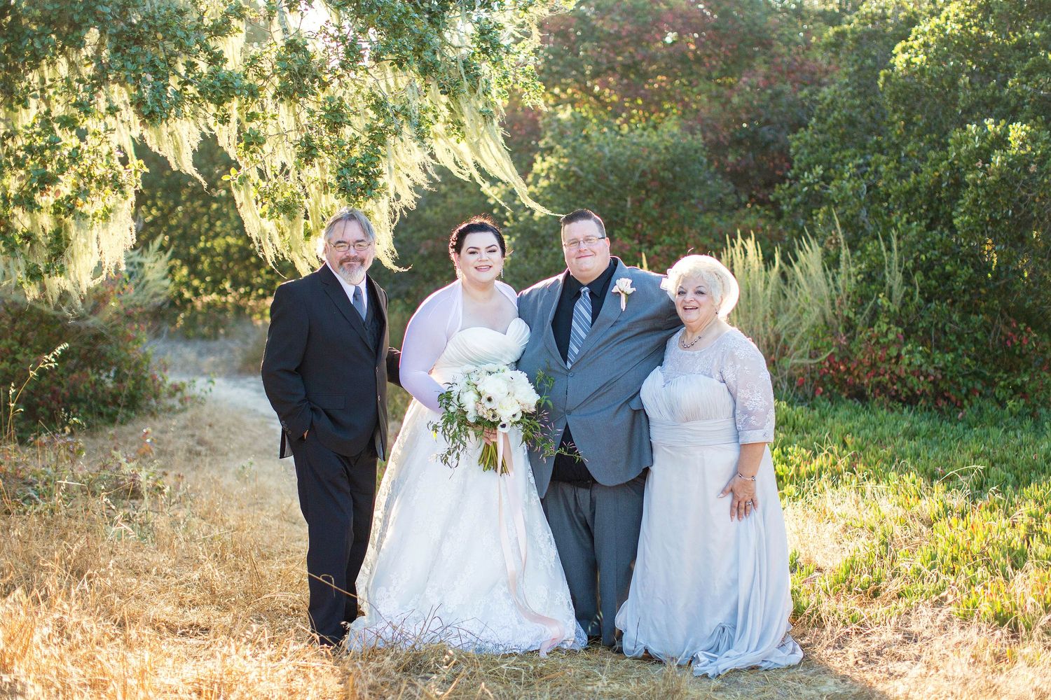 Outdoor wedding party photos in natural setting with greenery.