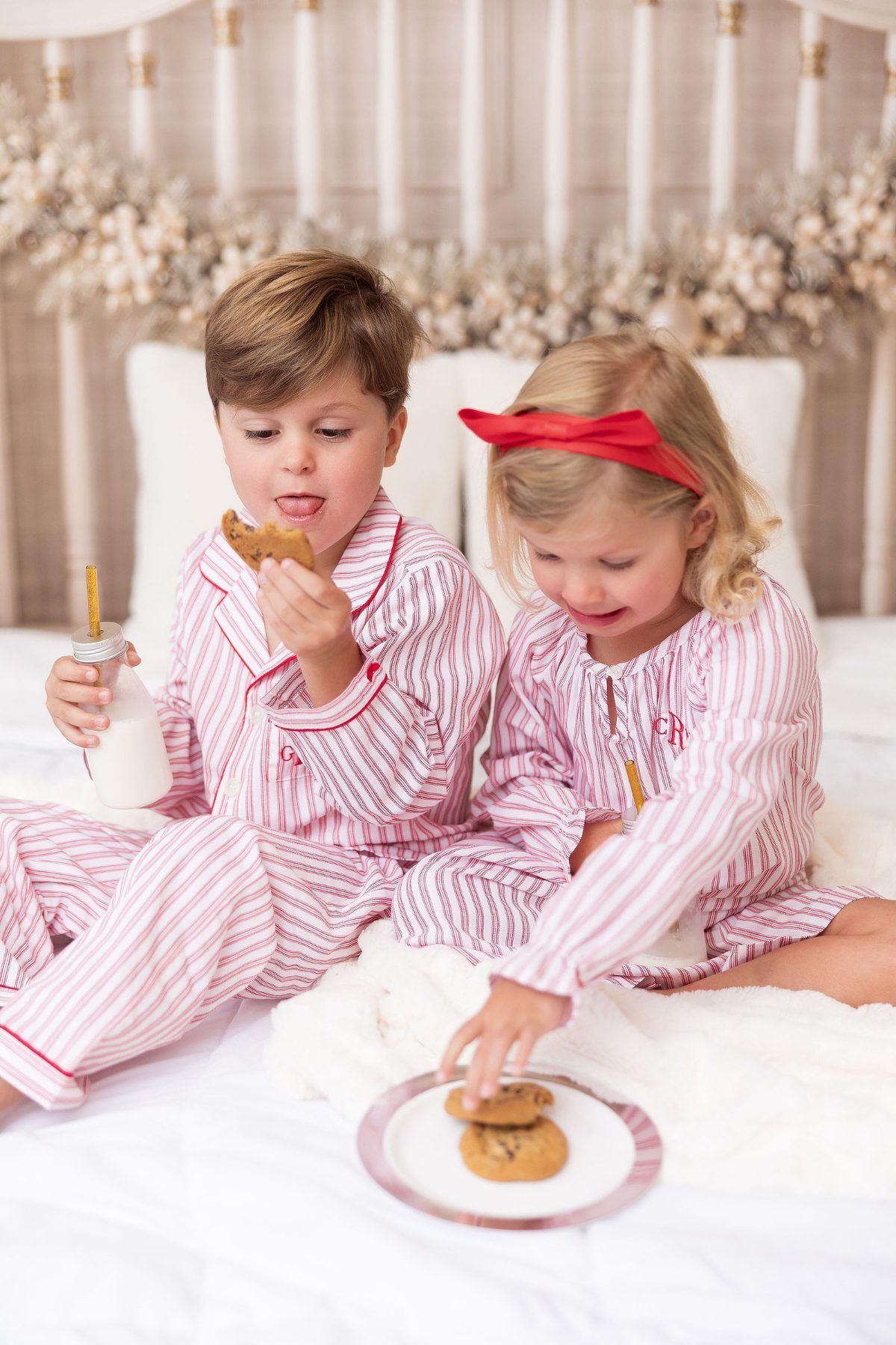 Siblings in striped Christmas jammies sharing cookies, Pacific Grove Christmas photographer