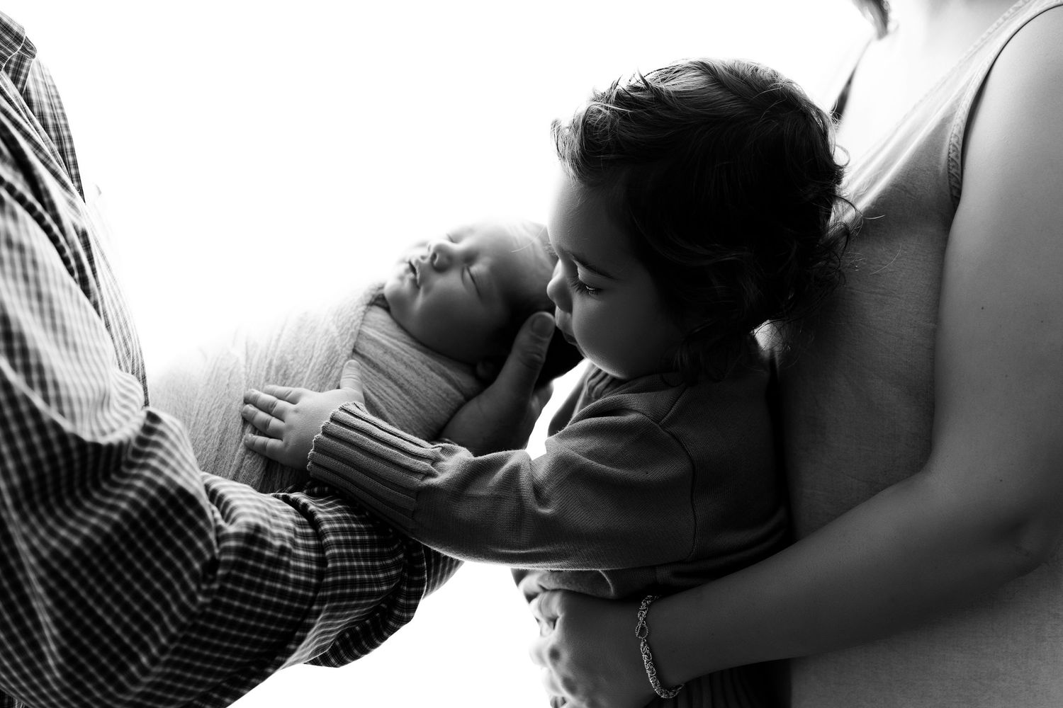Black and white series of intimate photos showing a couple tenderly embracing and interacting in natural light.