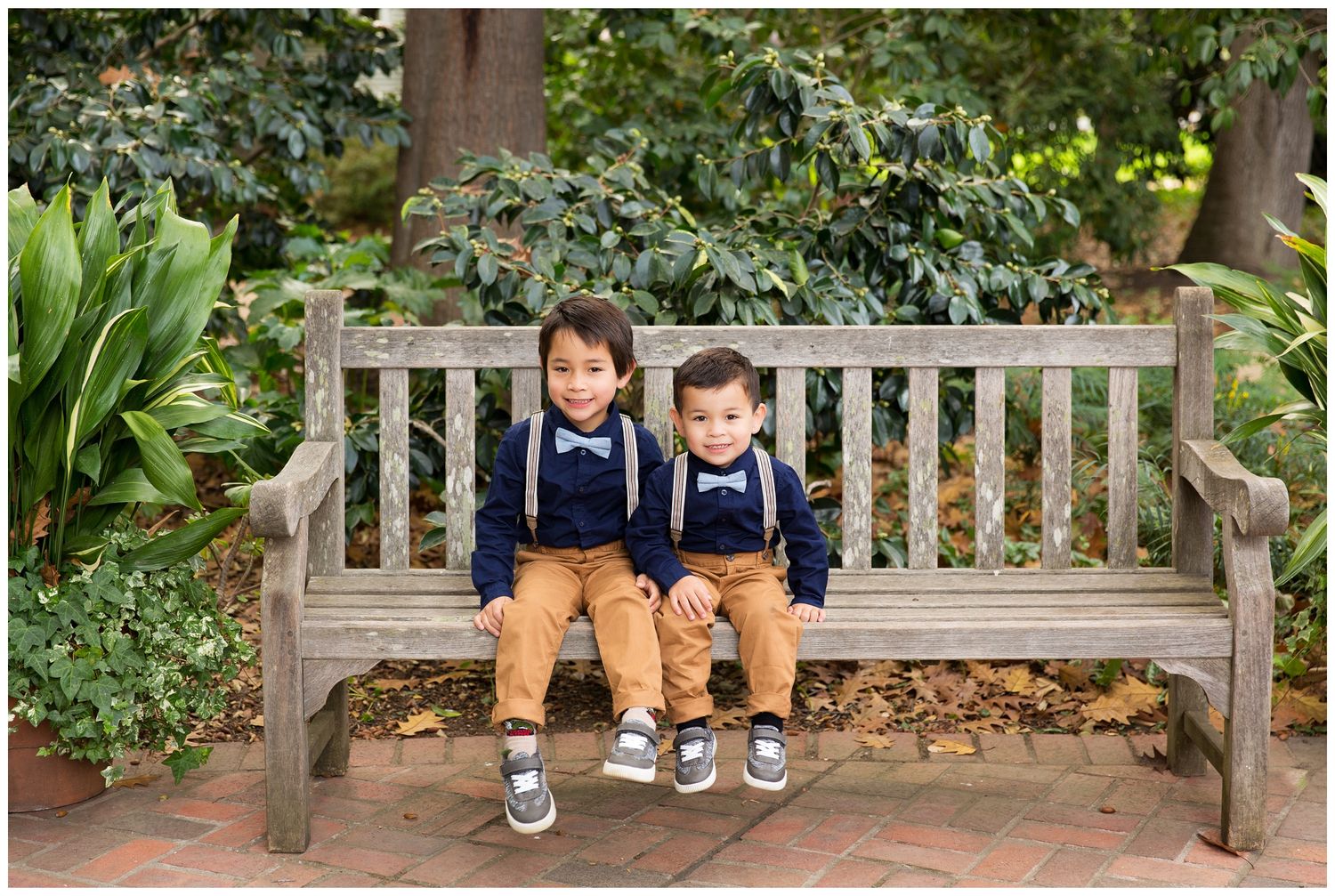Matching shoes and khaki pants of family members sitting on wooden garden benches surrounded by greenery.