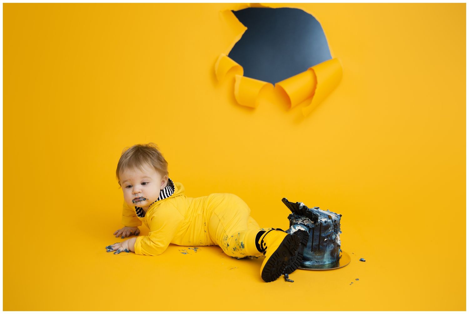 A series of seven yellow-themed graduation photos showing a baby in a cap and gown against a bright yellow backdrop.