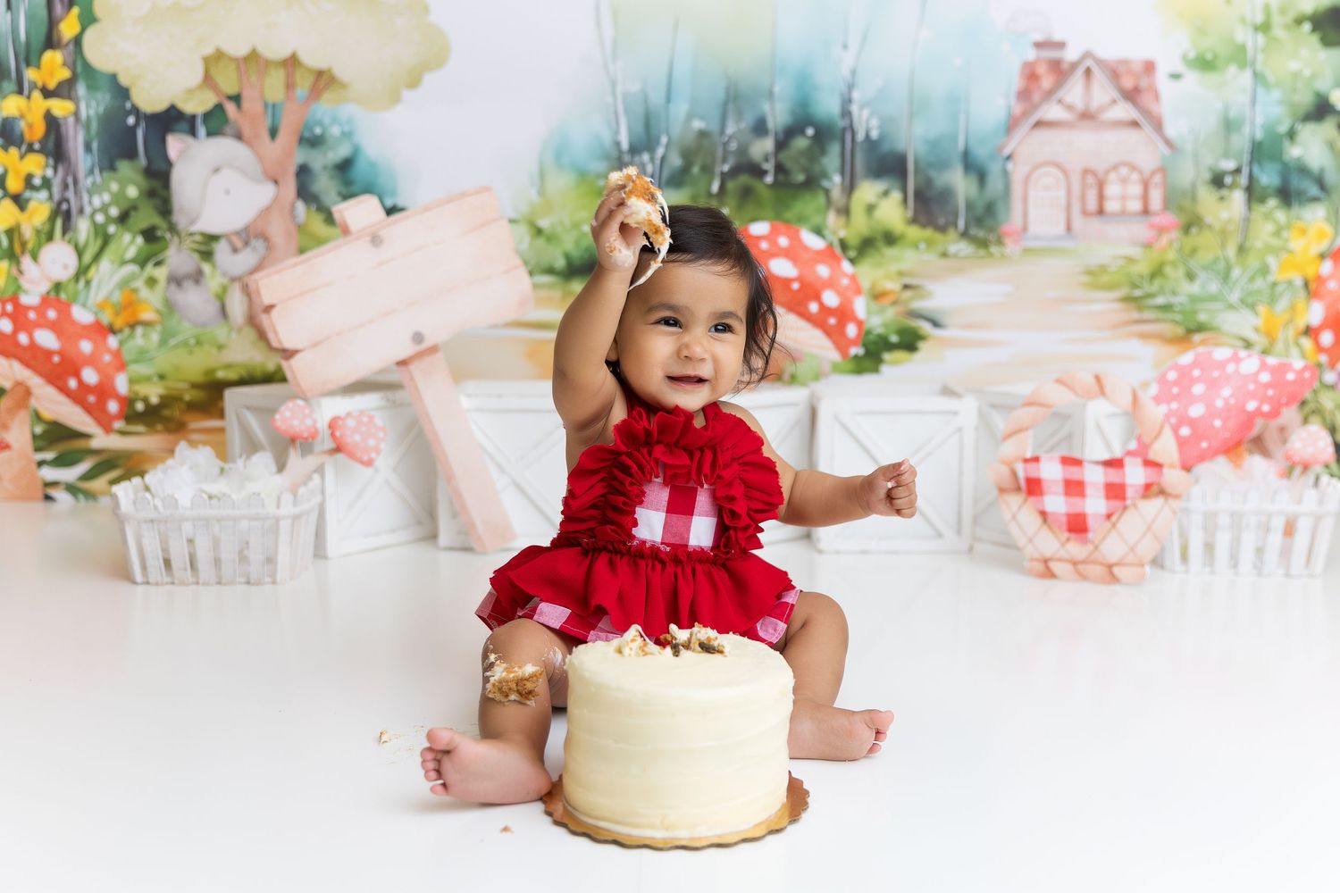 Whimsical garden party setup with cottage backdrop and yellow cake.