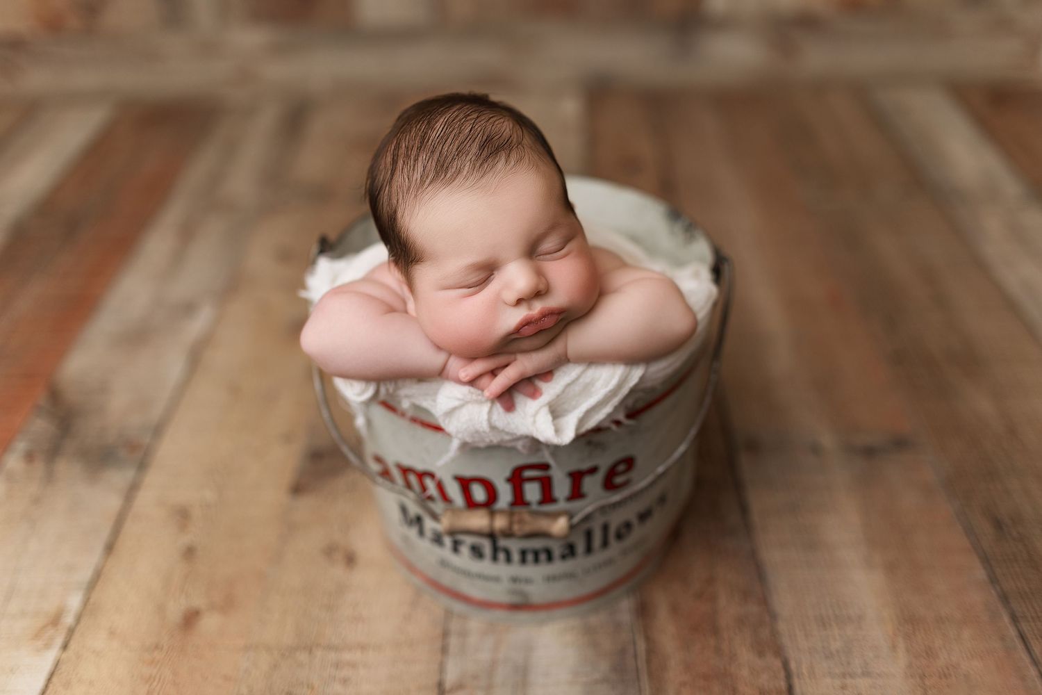 Artistically composed series of newborn baby photography images on wooden backdrop showing peaceful sleeping poses.