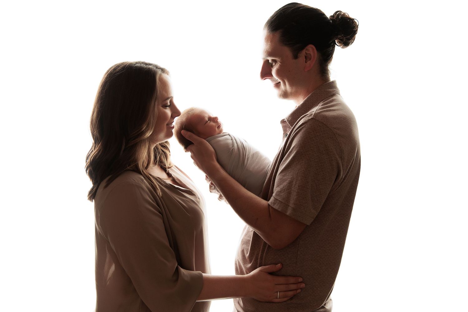 Silhouetted figures sharing intimate family moments against white background.
