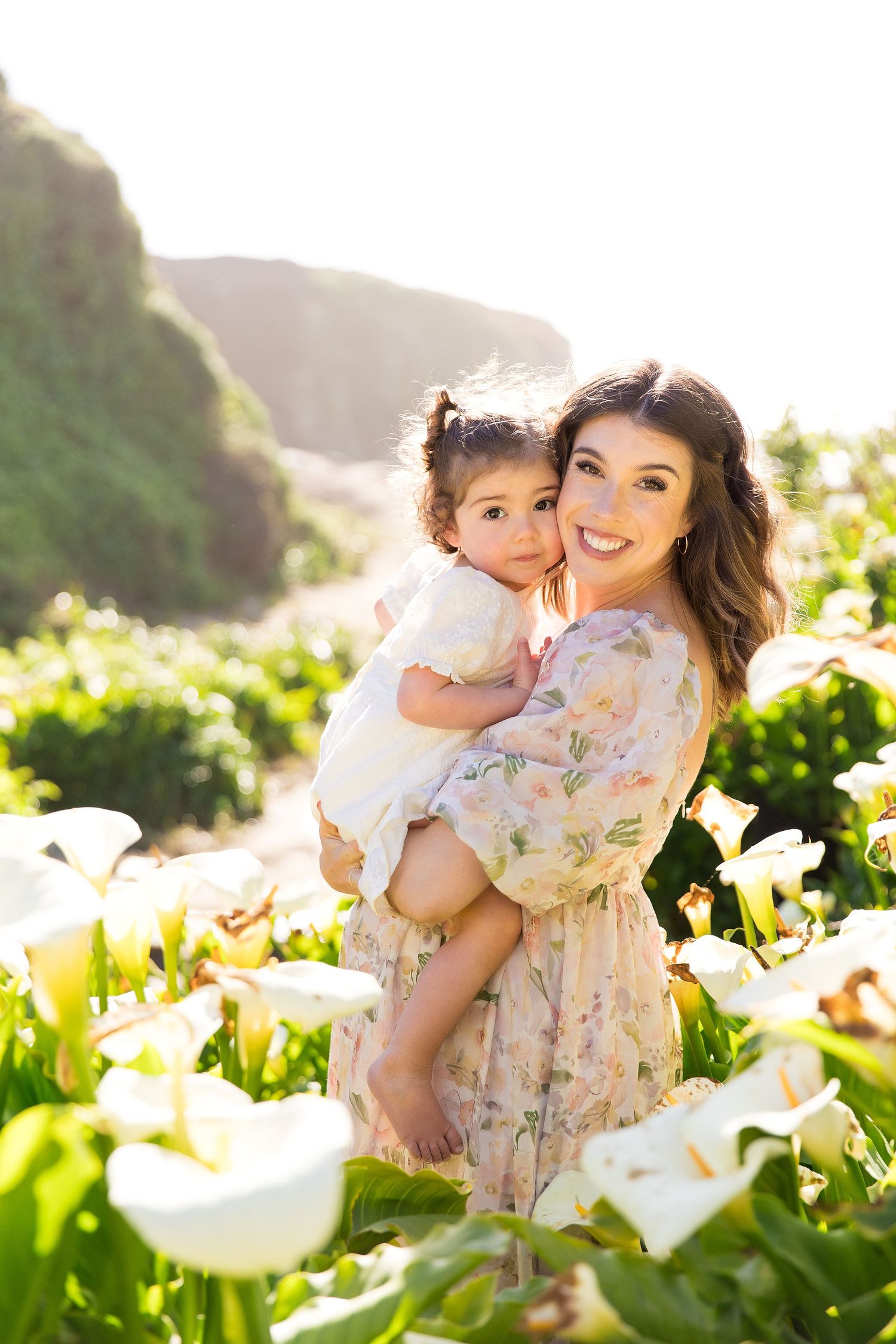 A floral spring photo session among blooming white calla lilies.