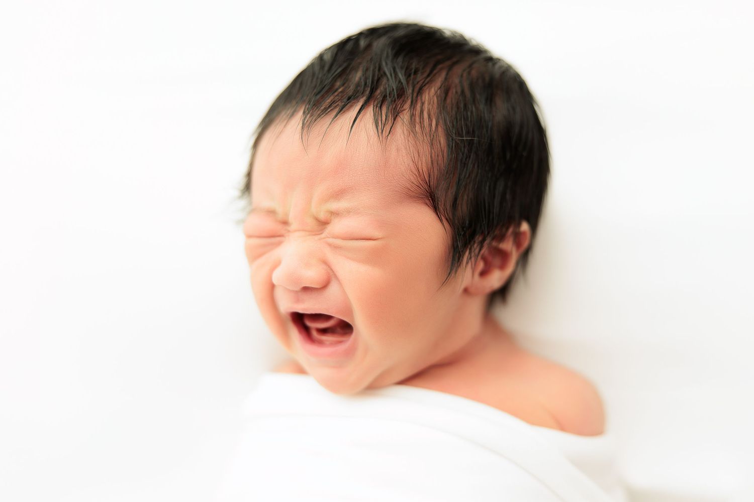 Series of expressive newborn poses showing different emotions on white background.