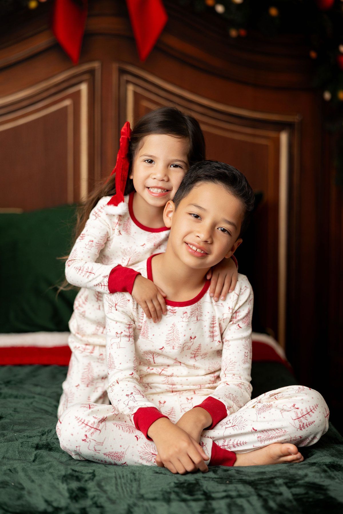 Brother and sister in matching Christmas jammies at a Milk and Cookies mini session in Monterey
