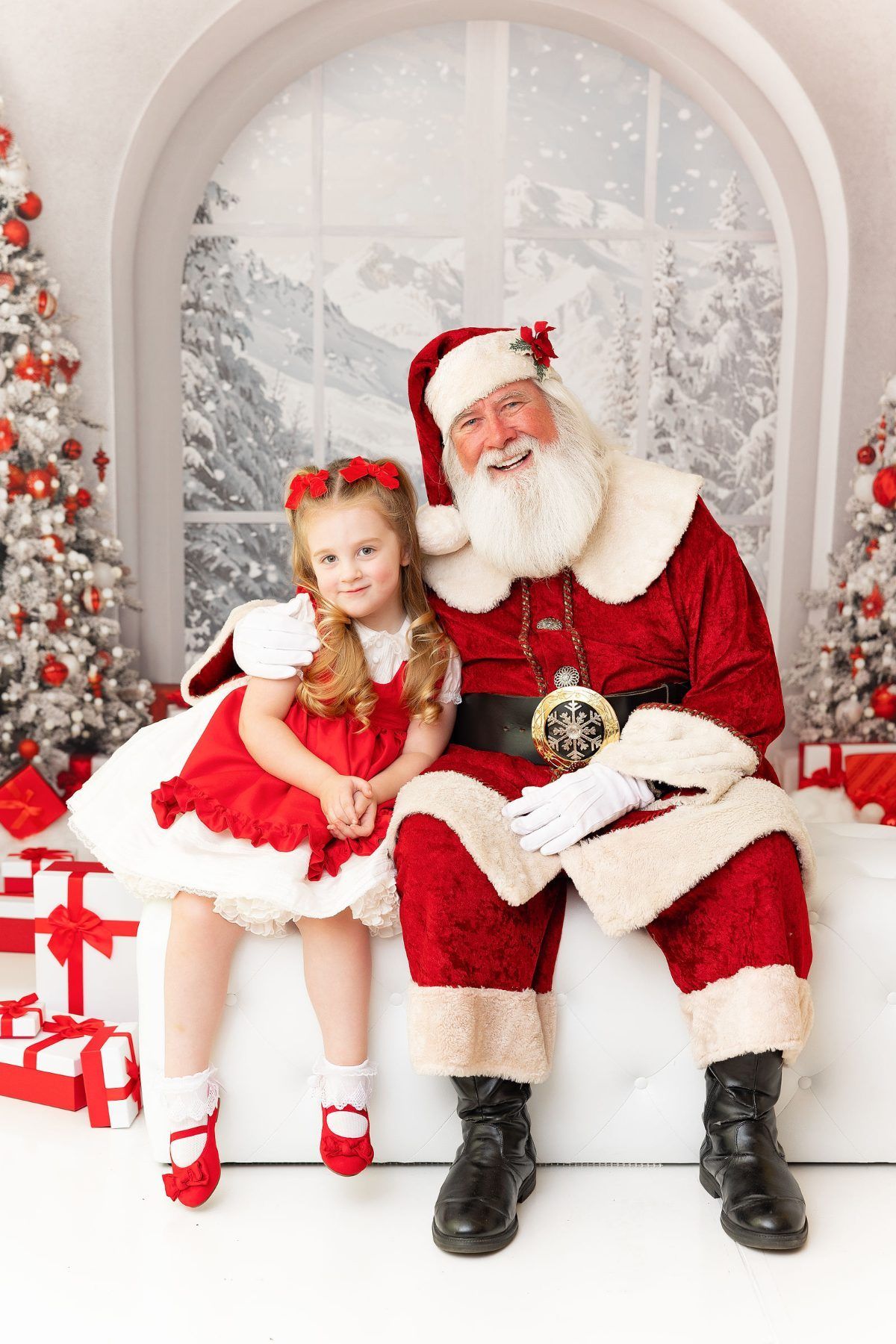 Classic Santa photo of a girl hugging Santa in a snowy winter Christmas set, Monterey Christmas portraits