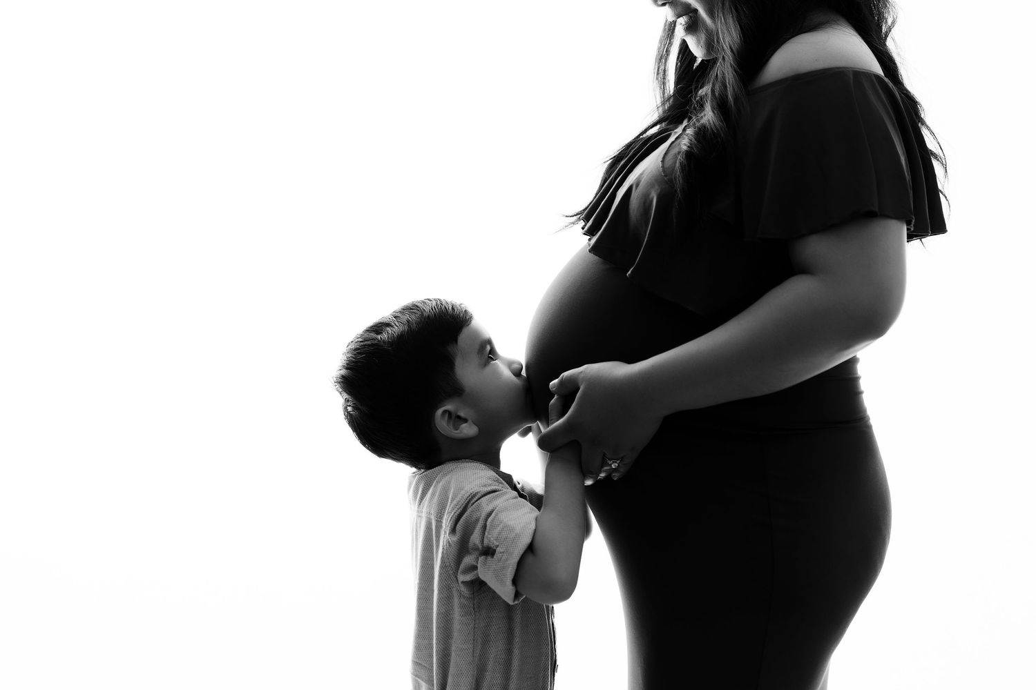 Black and white silhouette series showing intimate maternity moments.