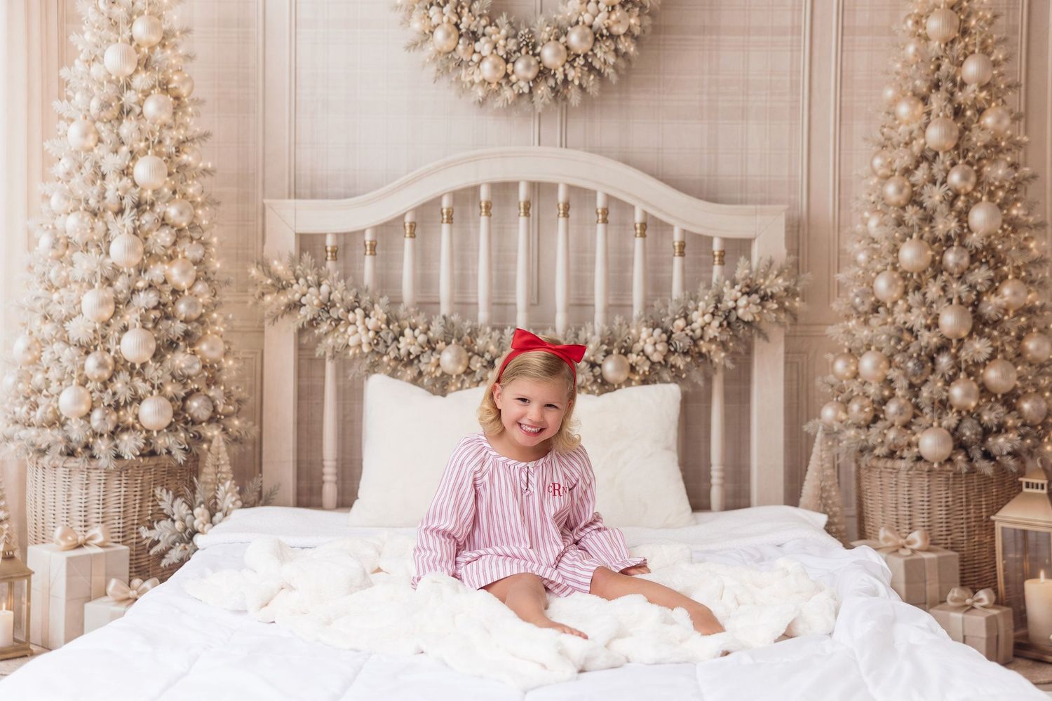 Girl in holiday jammies on the white and gold Milk & Cookies Christmas mini session bed in Pacific Grove