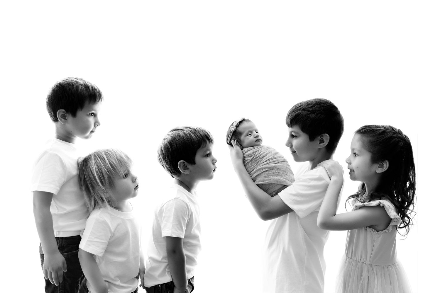 A black and white photo montage shows children in white shirts playing and interacting in different poses and expressions.
