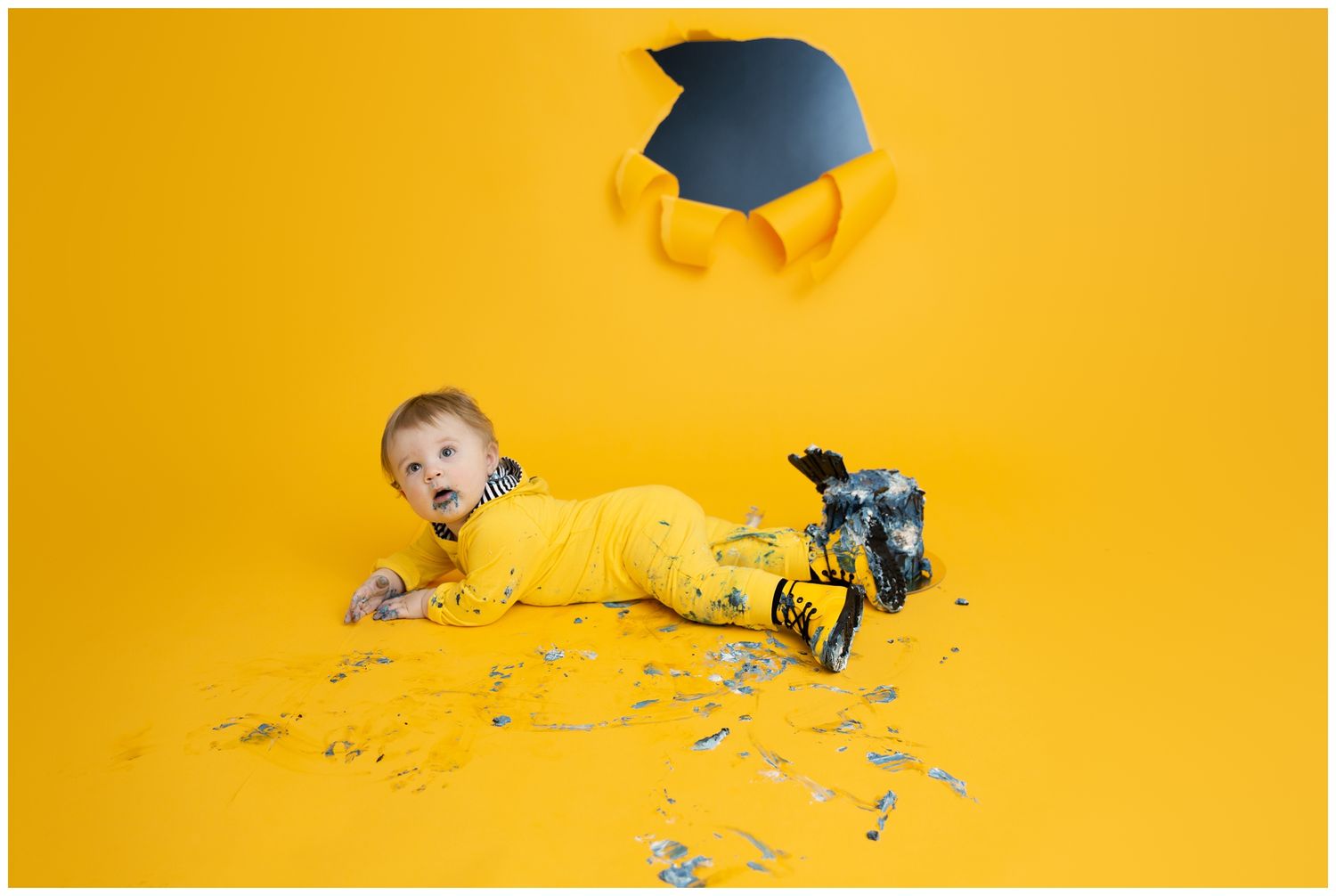 Yellow background studio photo with graduation cap and scattered confetti.