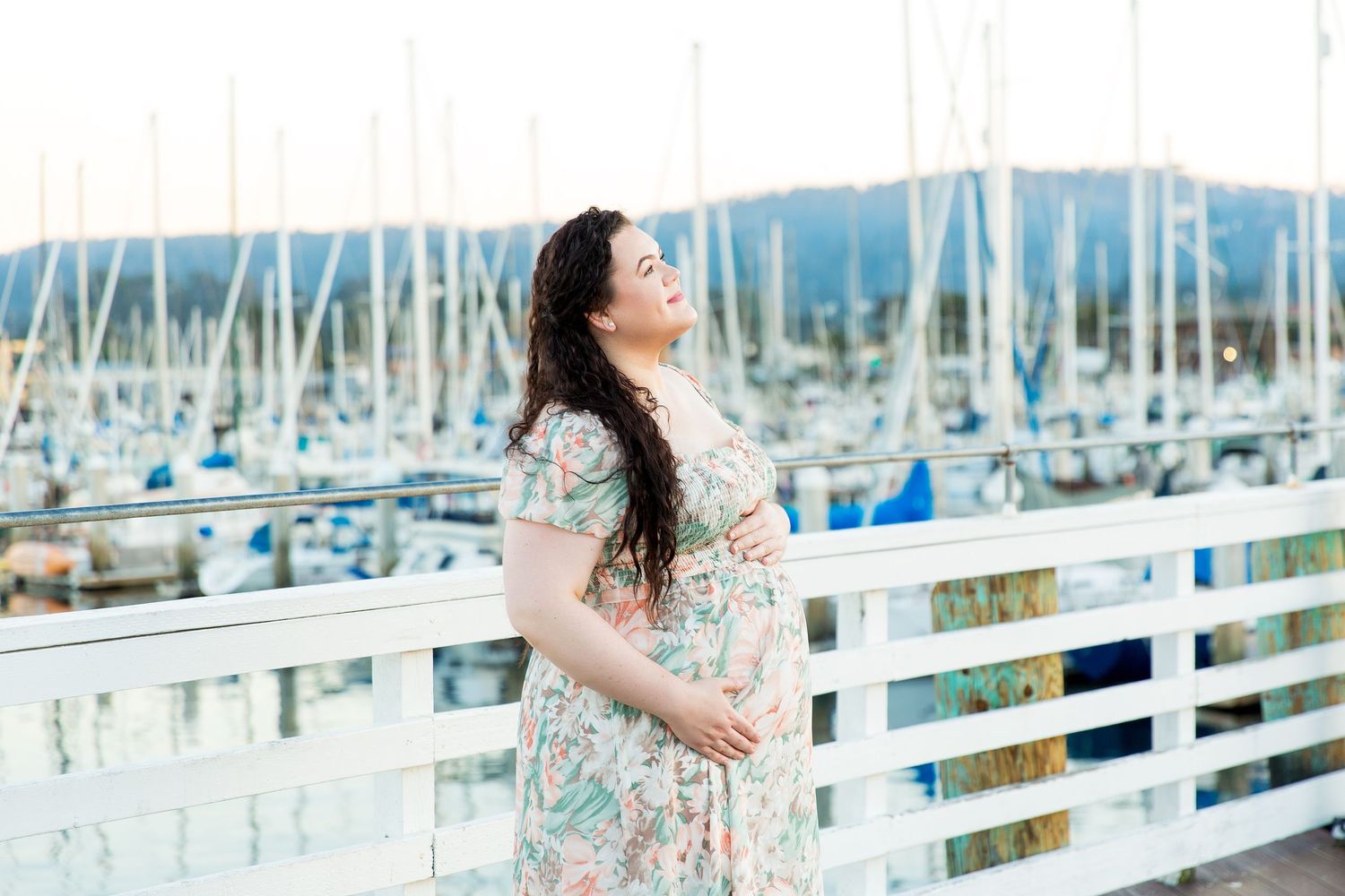 Long dress photo session by a waterfront marina  at Fisherman's Wharf with boats in the background.