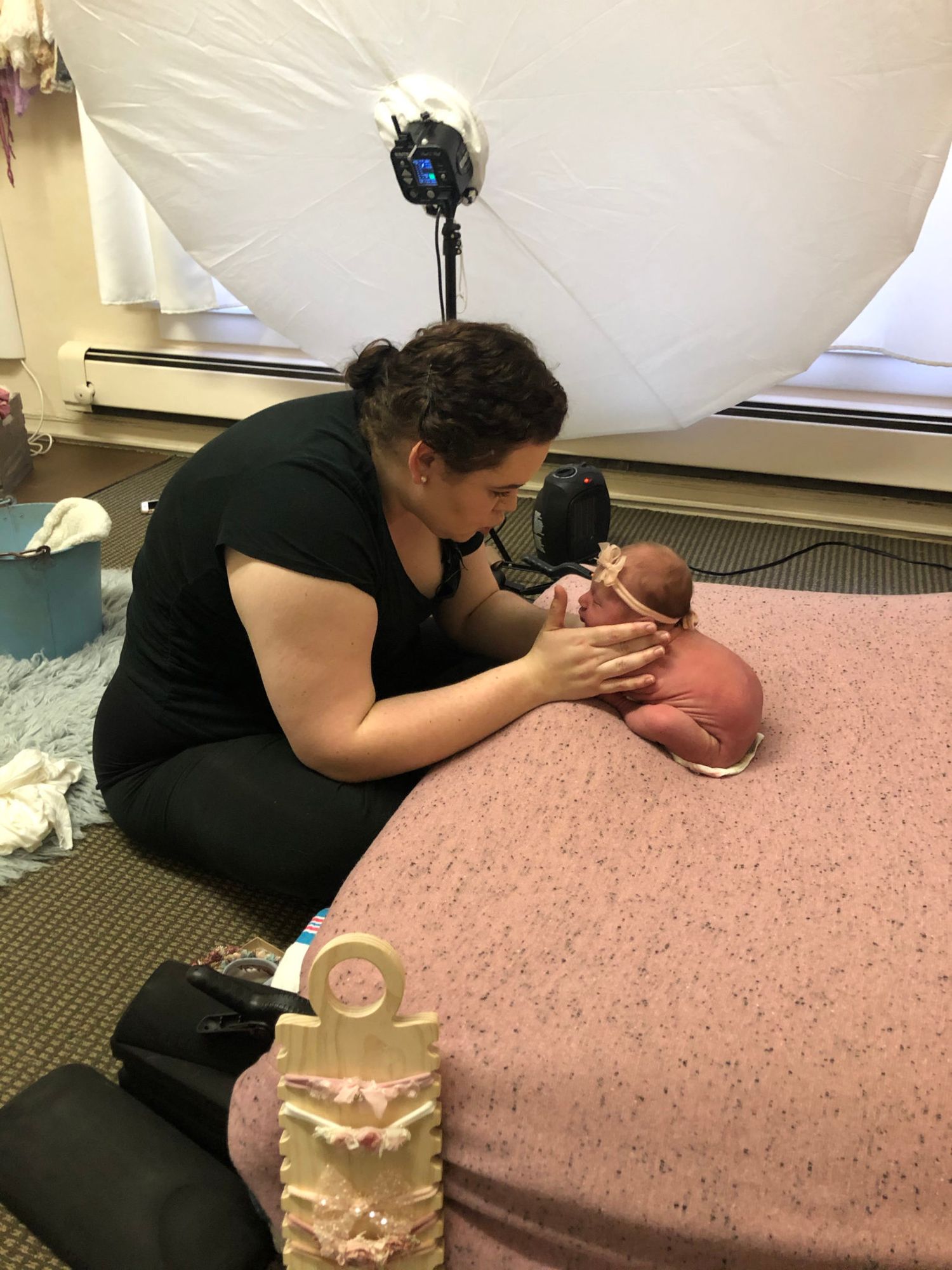 Therapist performing craniosacral therapy treatment on a client lying on a massage table.