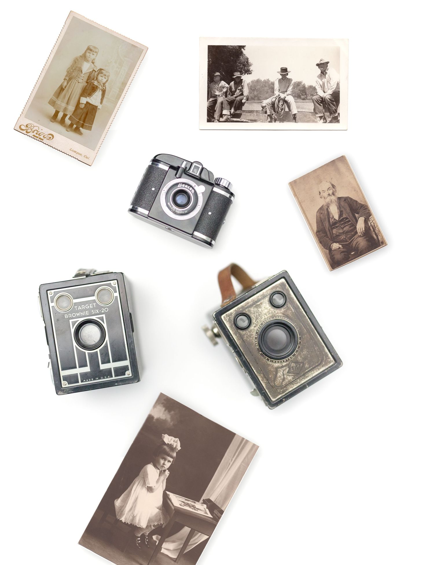 Vintage photography collection featuring antique cameras and old sepia photographs arranged on white background.