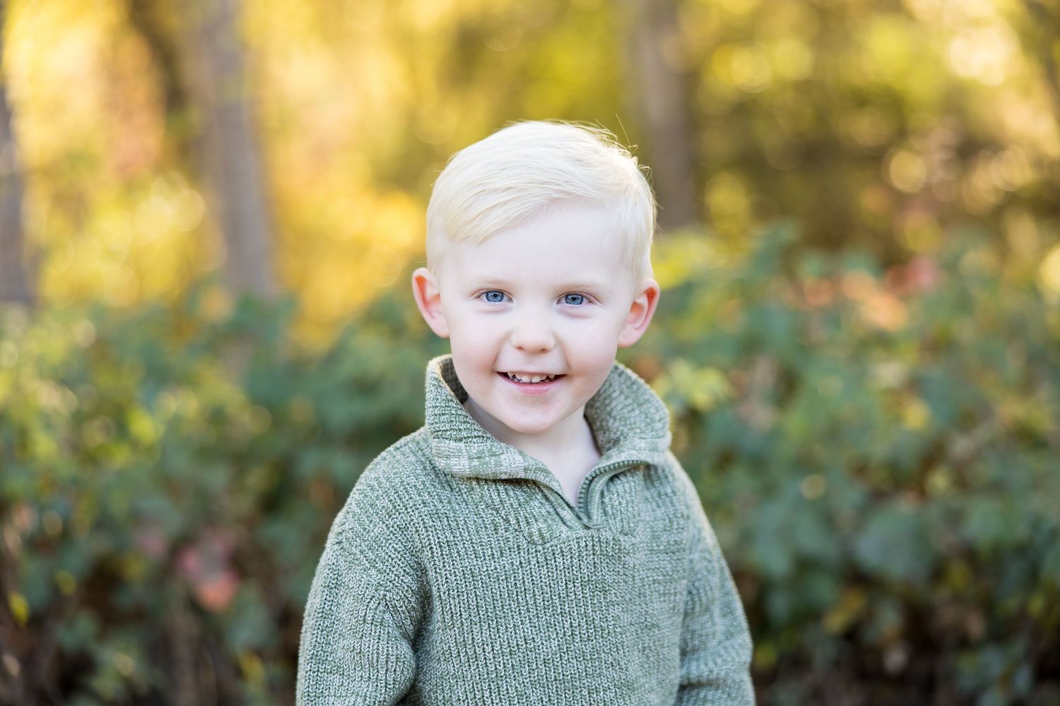 Candid portraits in a natural outdoor setting with green foliage backdrop.