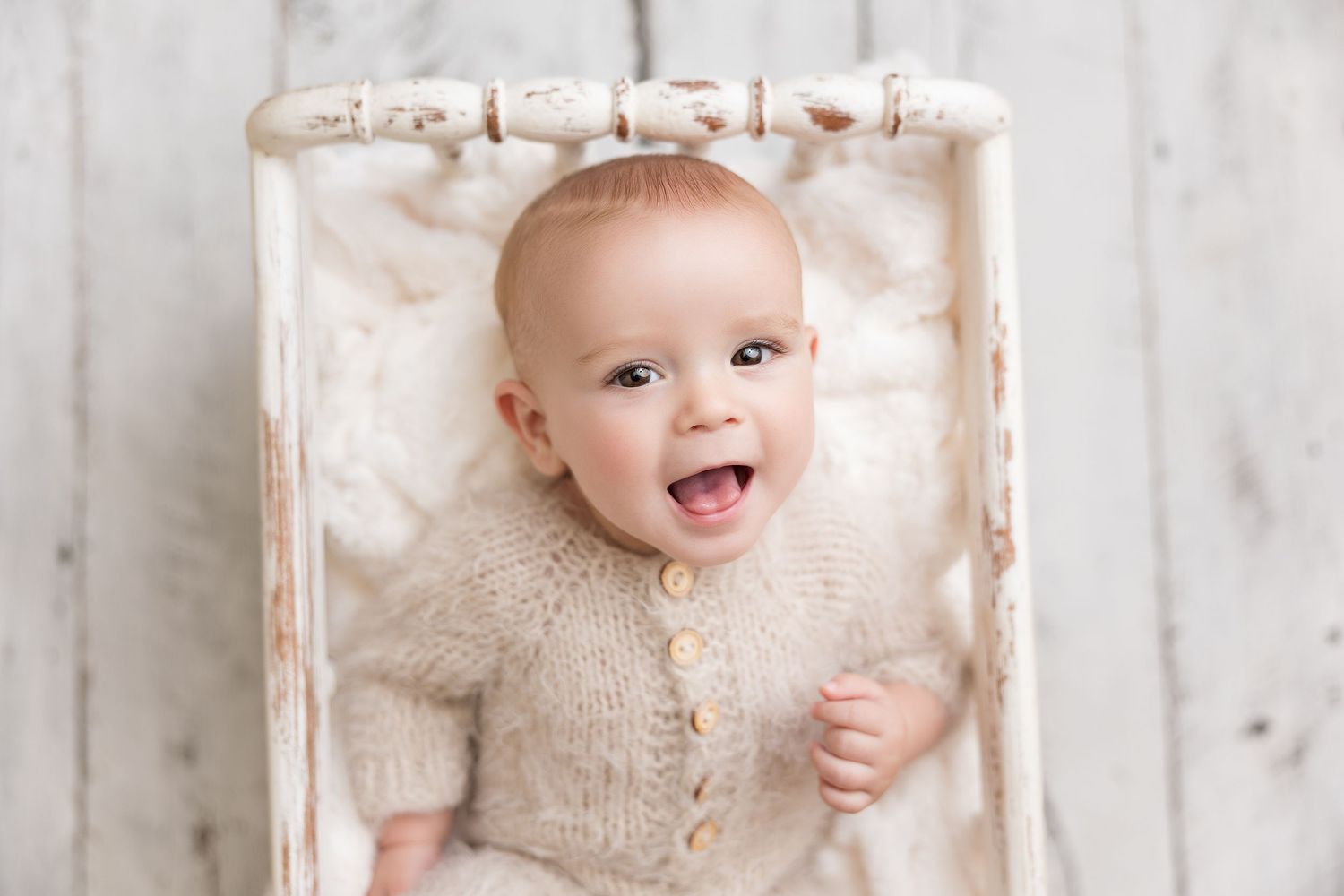 Rustic white wood backdrop baby photography with vintage styling.