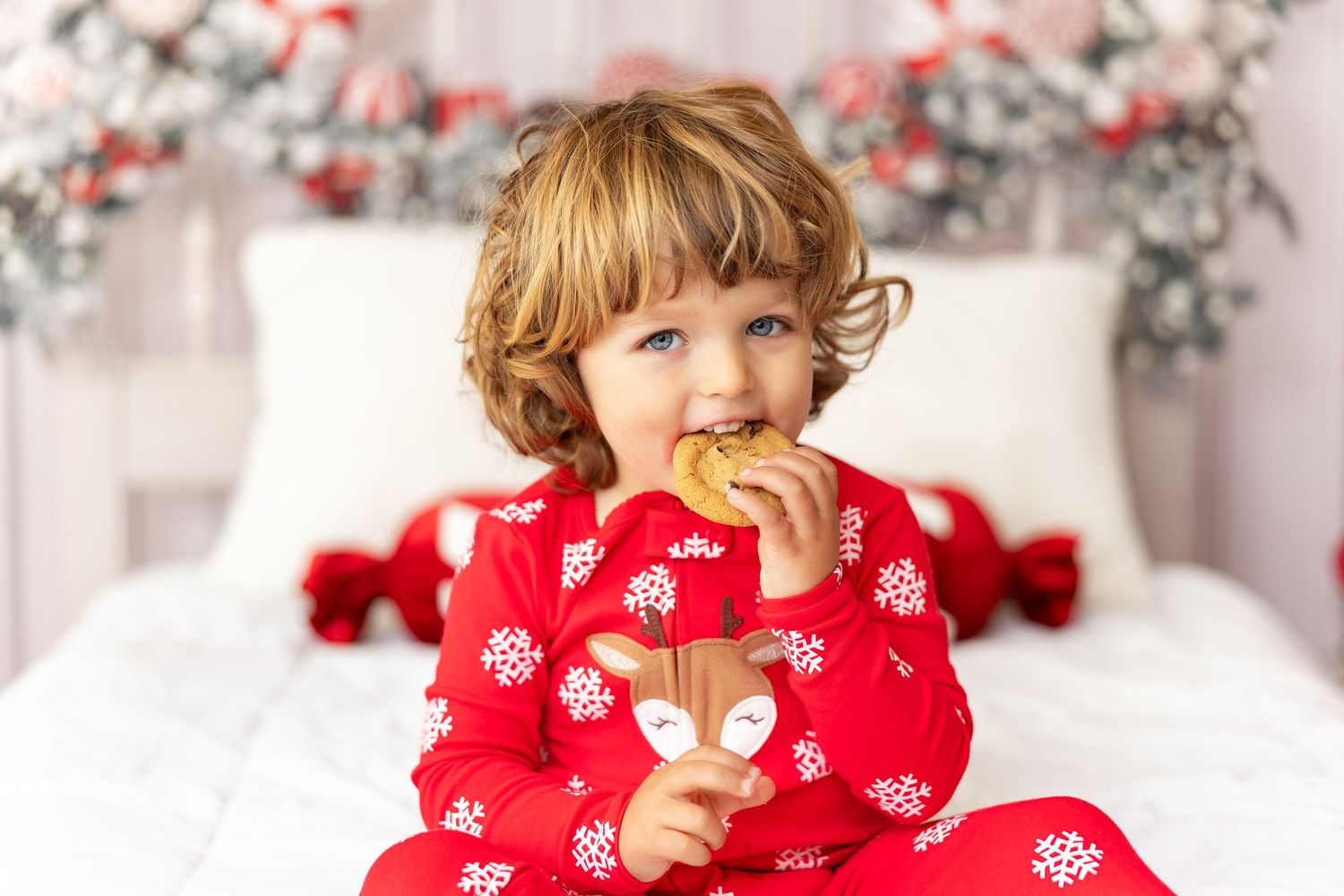 Festive Christmas scene of matching pajamas and holiday decor with red and white floral backgrounds.