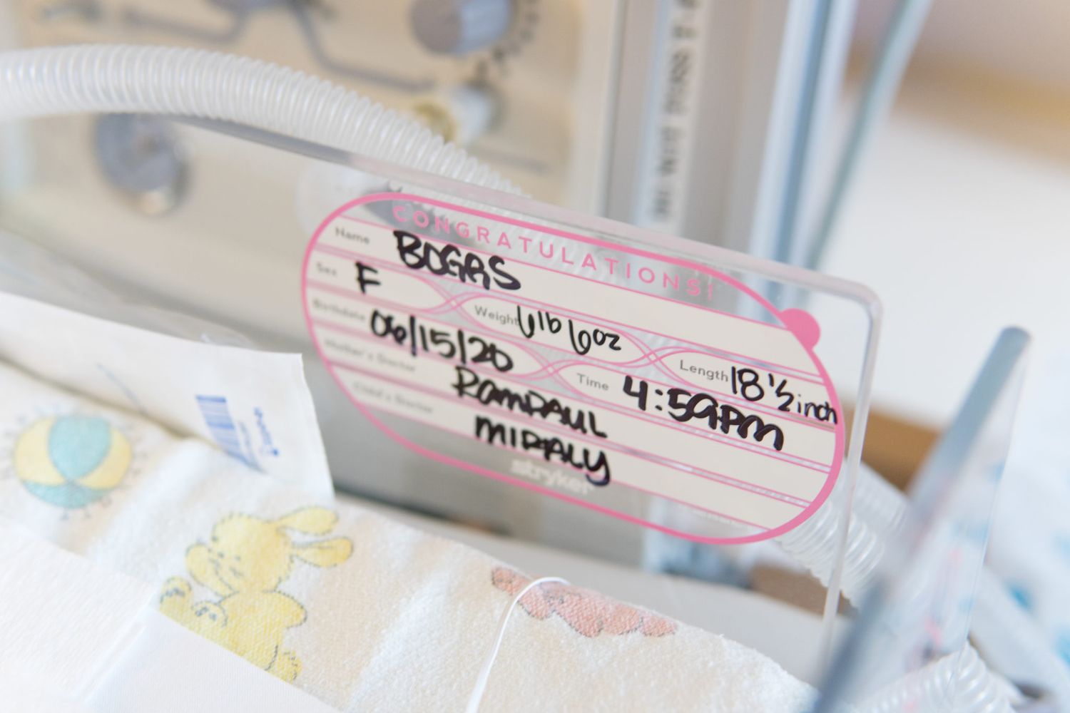 A close-up view of labeled medical vials and supplies arranged in a row on a light colored surface.