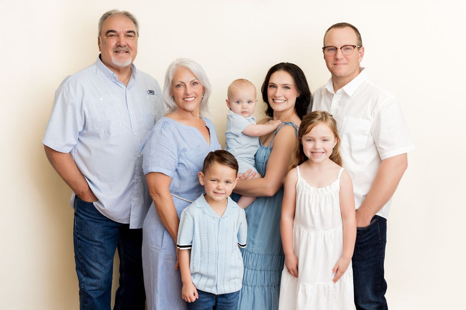 Multi-image sequence showing a casual family group posing in studio setting against neutral background.