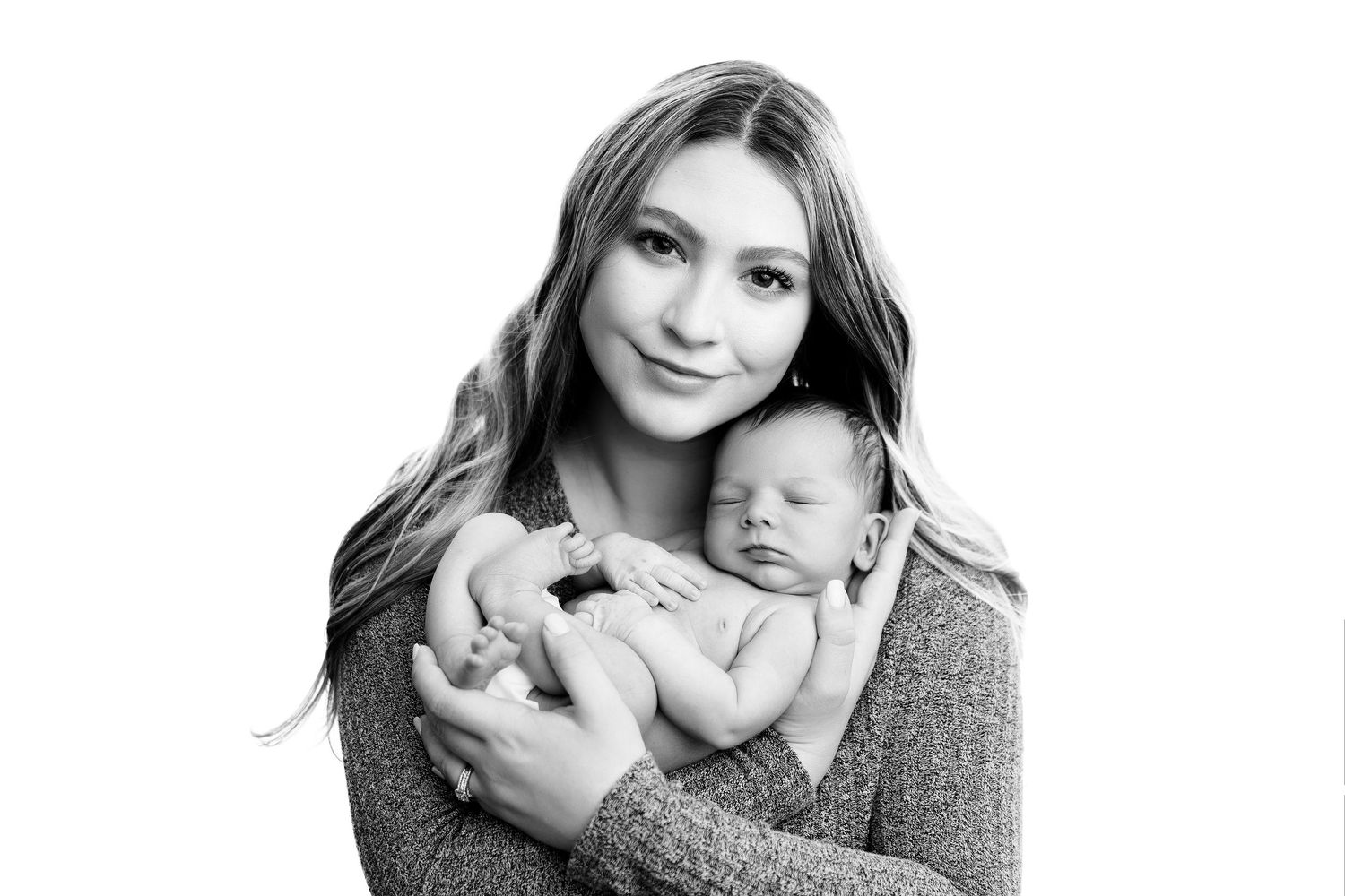 Mother and newborn portraits in soft black and white style.