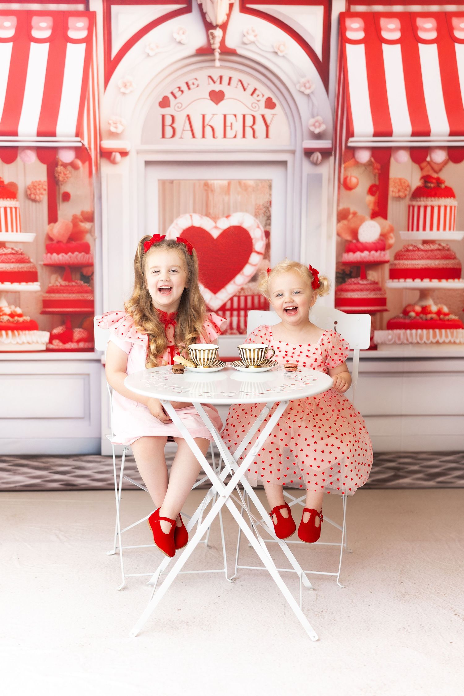 A charming Valentine's themed bakery setting with red and white striped decor and heart accents.
