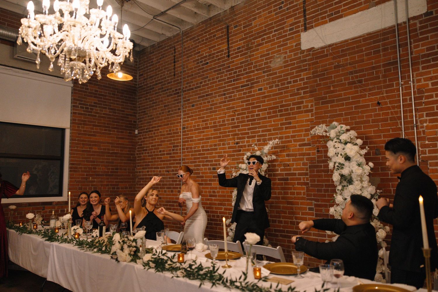 bride and groom dancing at head table