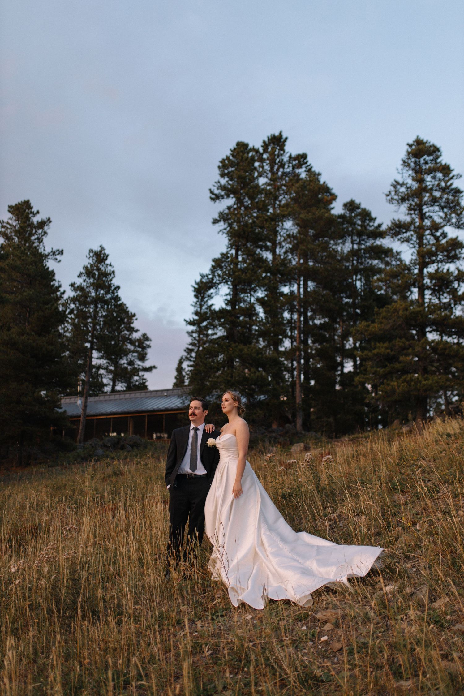 bride and groom holding hands, posing for portrait