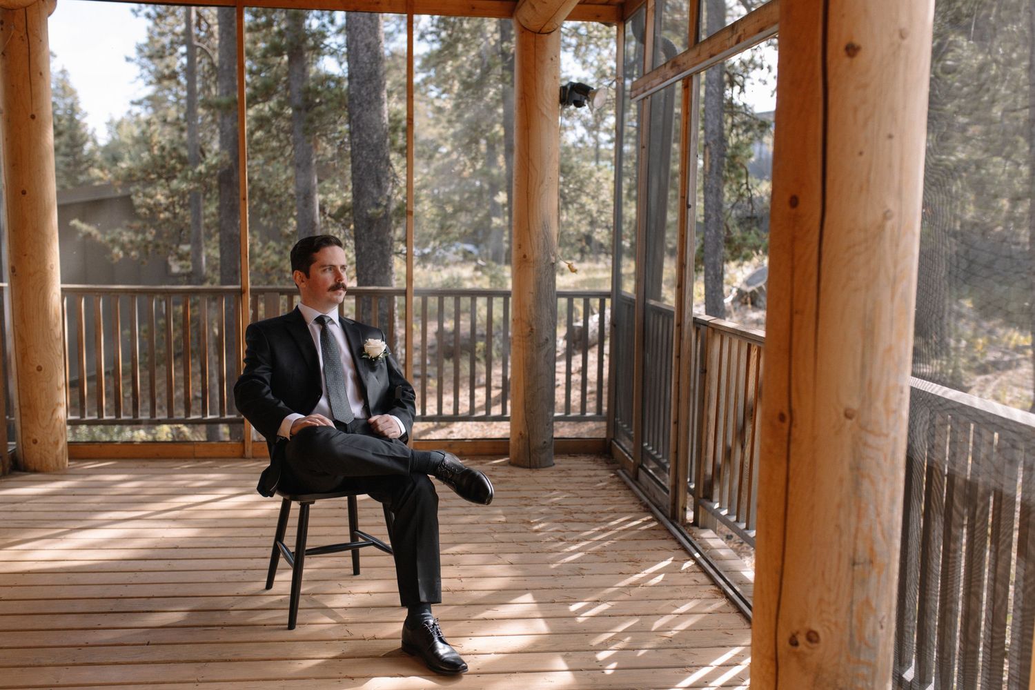 groom sitting down, posing for portrait