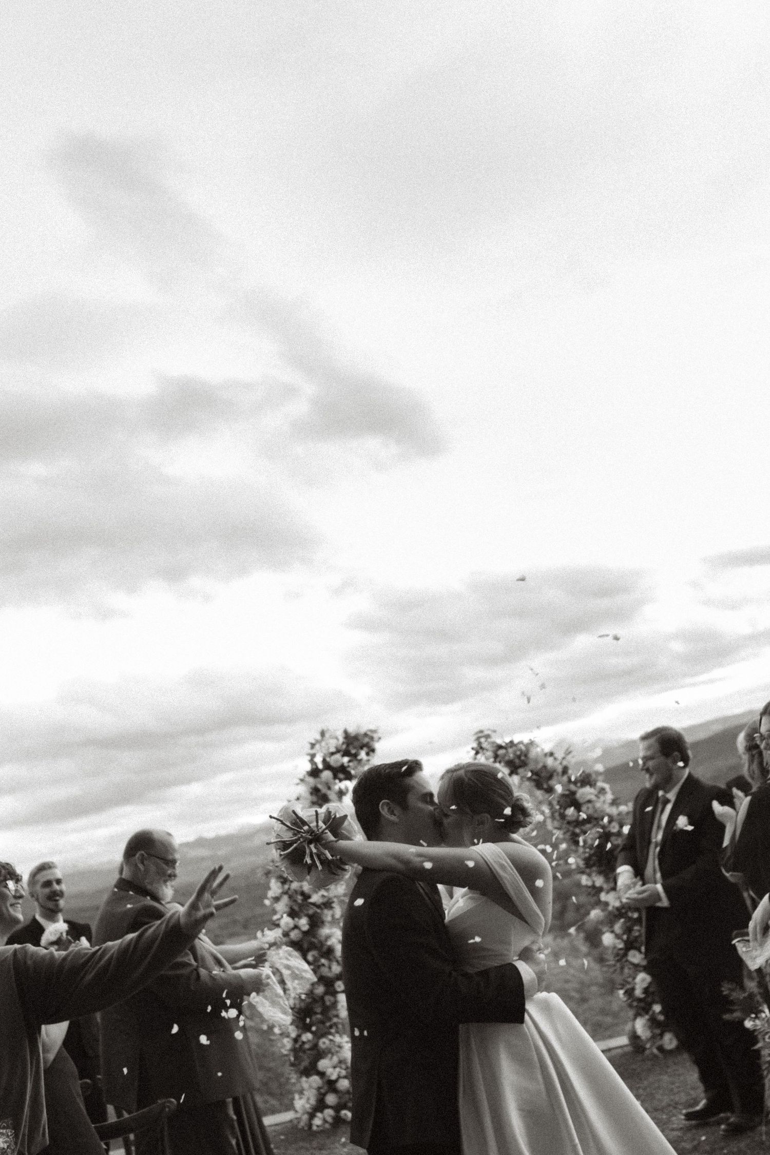 Bride and groom kissing in aisle