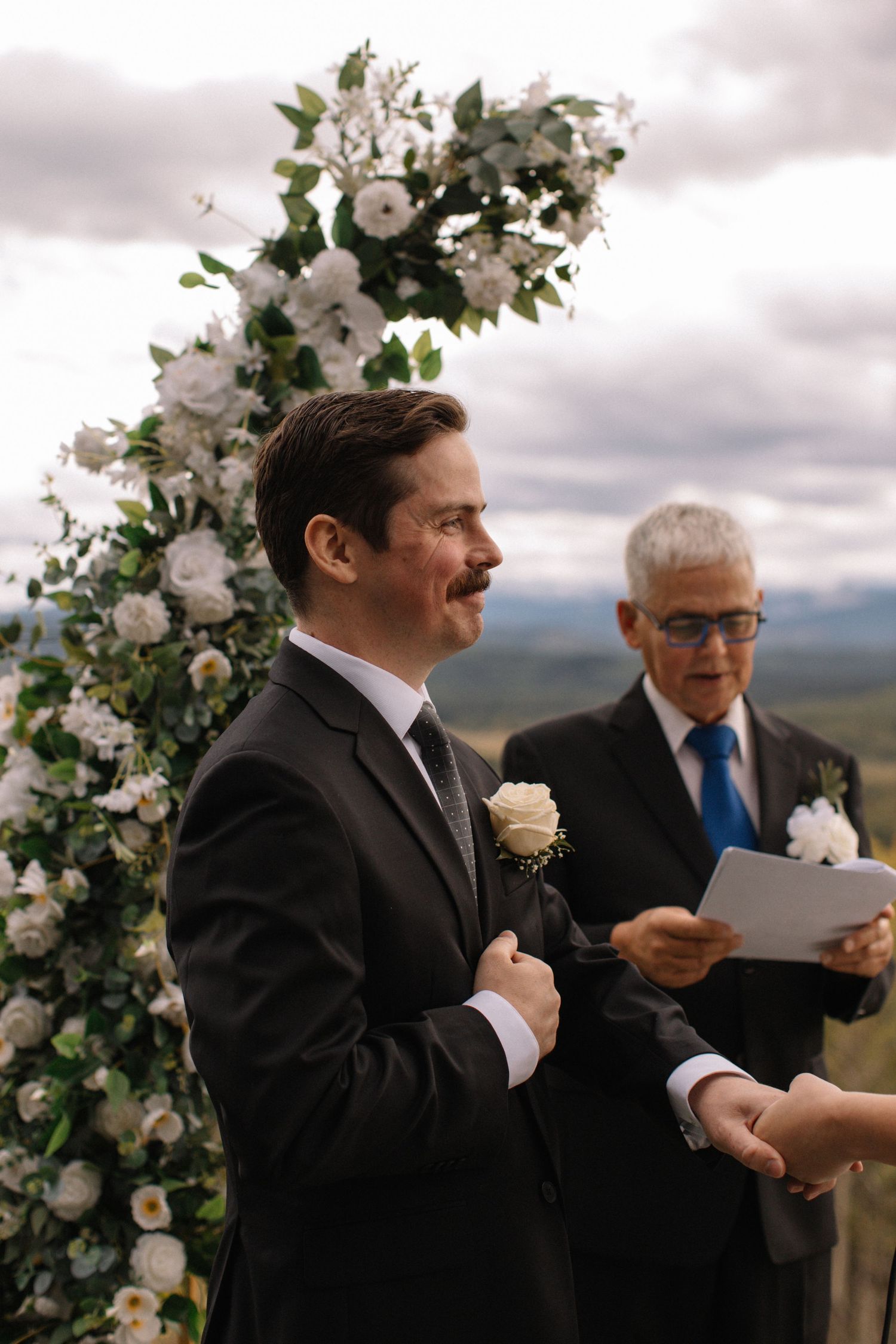 groom smiling at bride