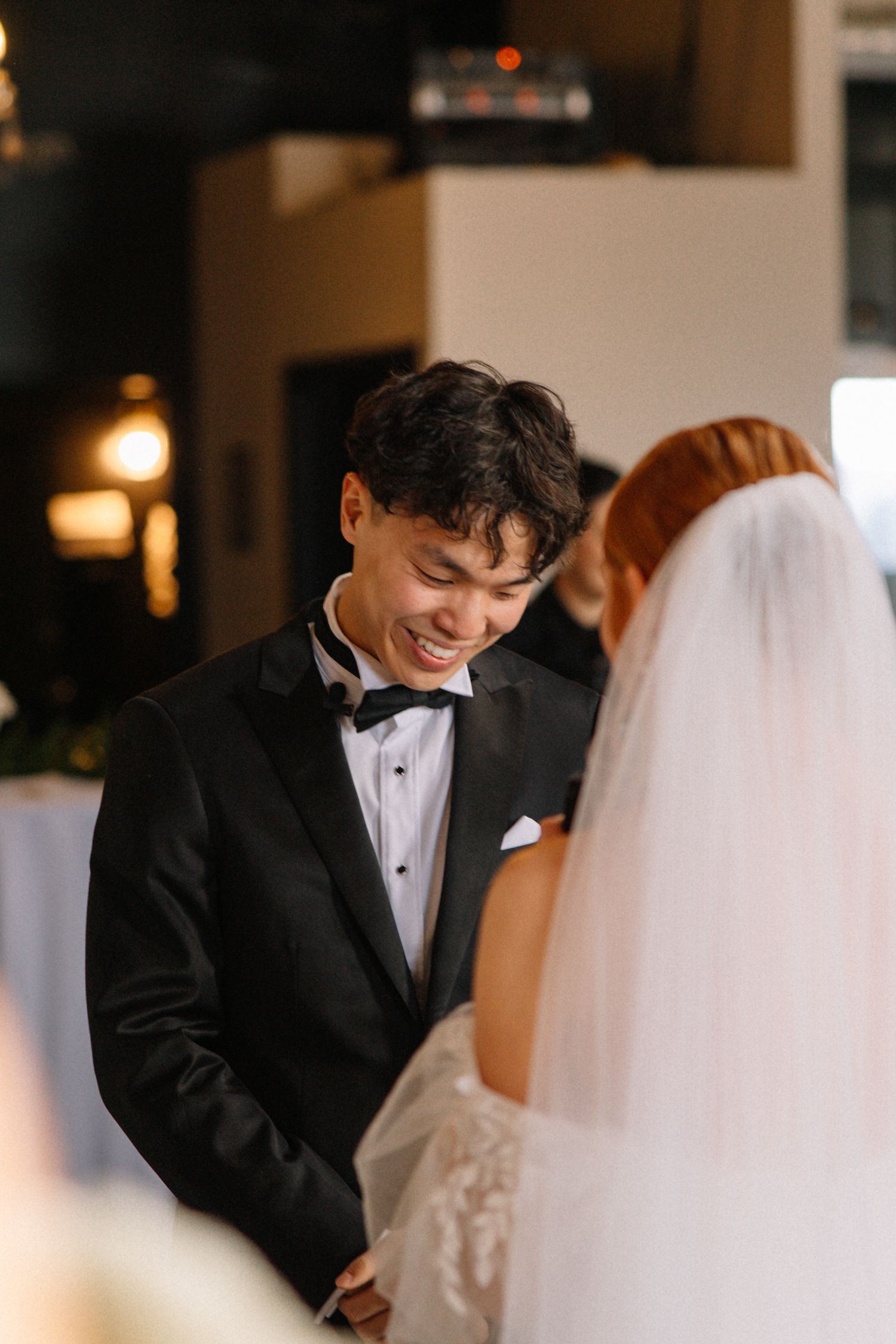 Candid moment during wedding ceremony with couple exchanging vows.