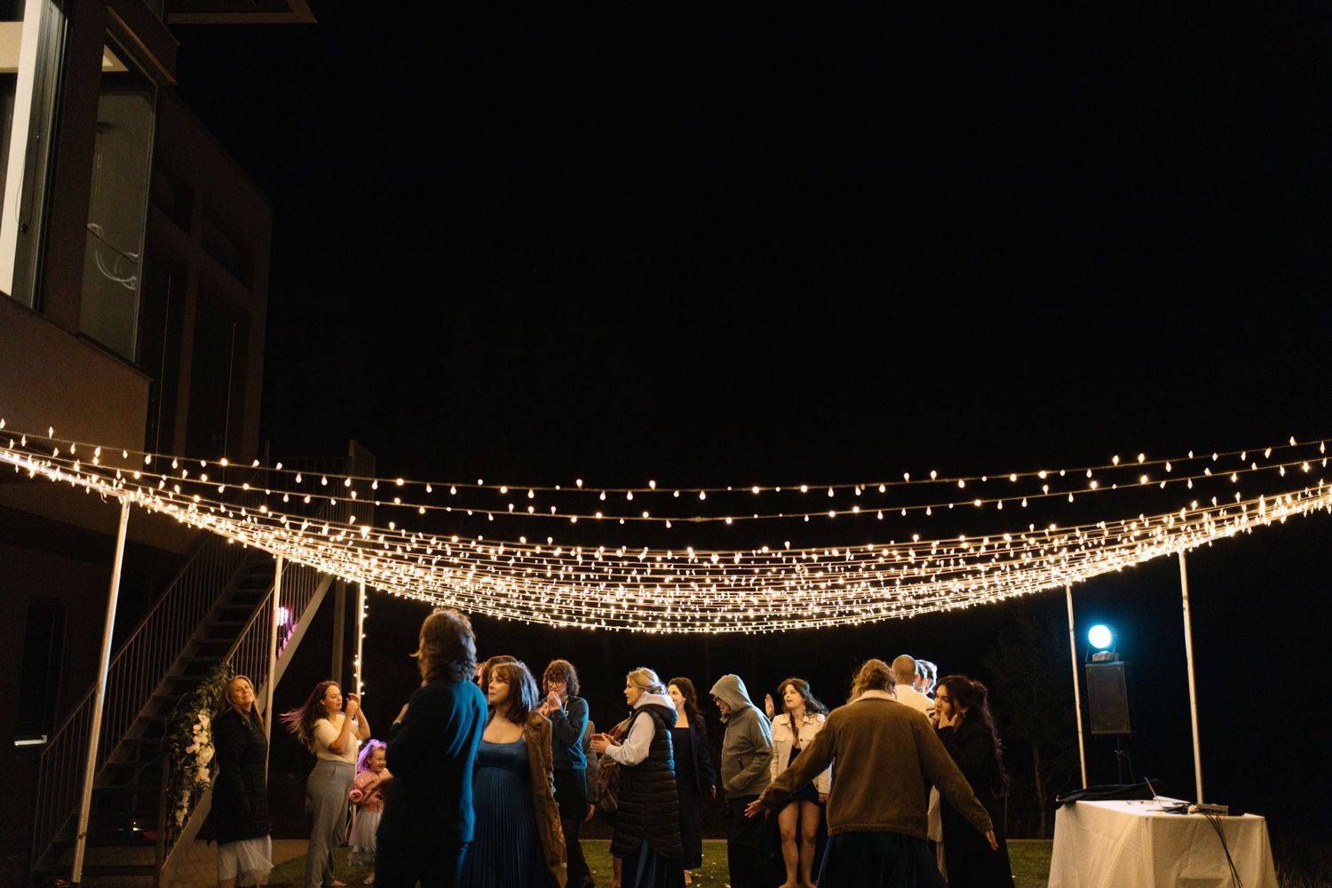 wedding guests dancing at the reception at night