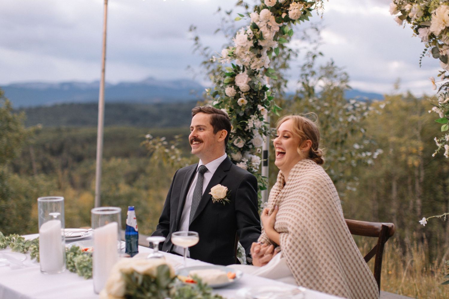 Bride and groom at head table laughing